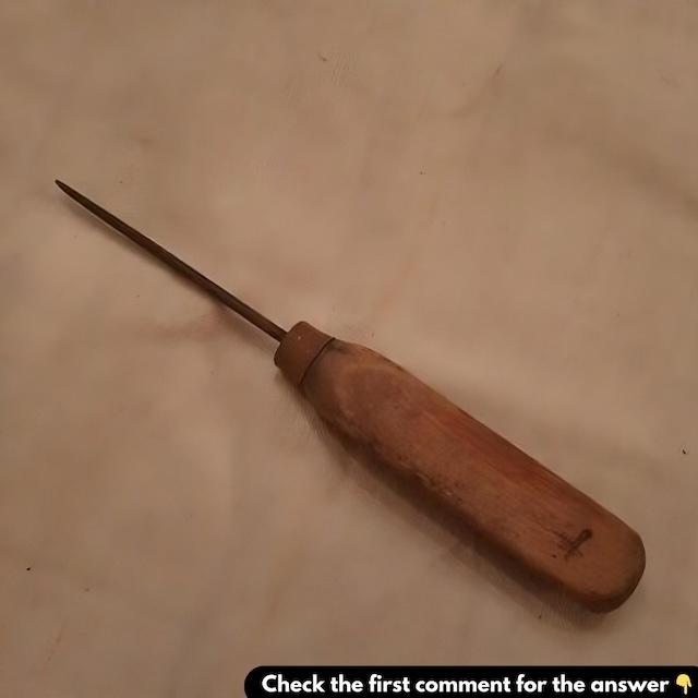 A classic vintage awl with a wooden handle, showing signs of age and use