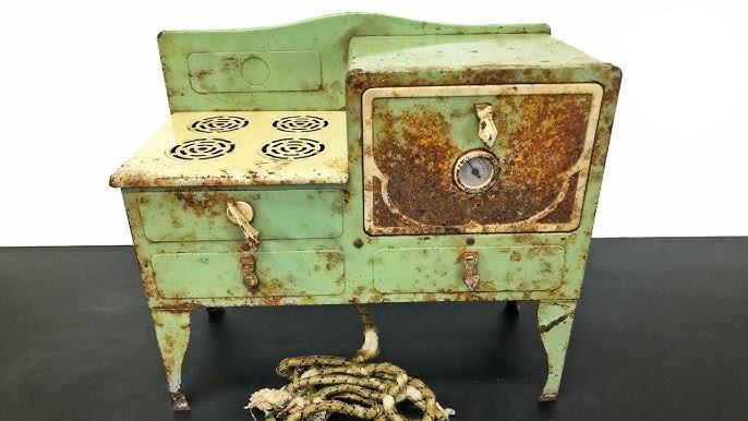 Covered in rust and showing signs of age, this Empire Metalware toy stove from the 1930s waits to be restored, a reminder of its long-forgotten role in many childhood kitchens.